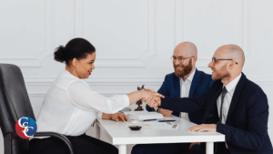 A professional handshake between two individuals over a wooden conference table, representing a successful business agreement or partnership. The background is softly blurred to focus on the connection, tailored for a featured image about private business lenders.